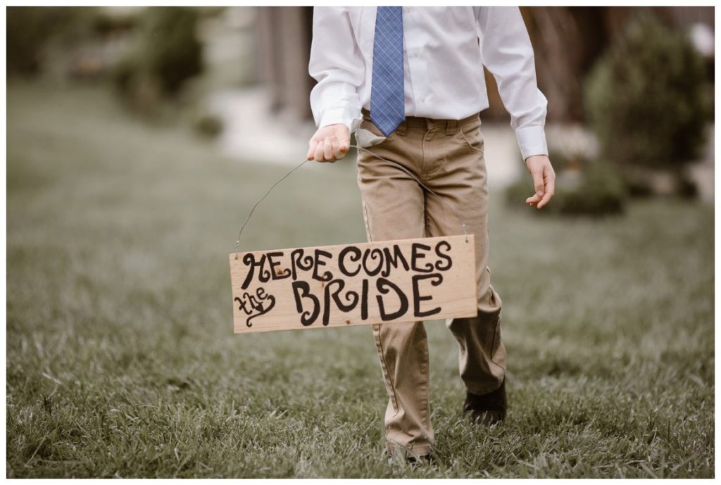 Wooden here comes the bride sign for wedding